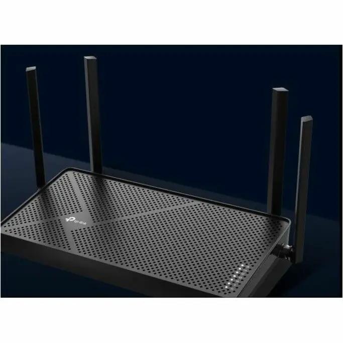 TP-Link Archer BE3600 WiFi 7 router with four external antennas on perforated black top, placed on desk