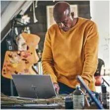 HP ZBook Studio G11 Mobile Workstation laptop in gray finish, 32 GB RAM, in a workshop with a man in an orange sweater