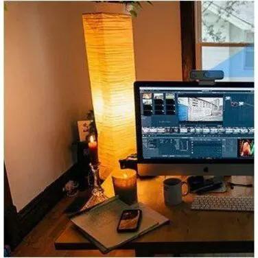 ROCWARE RC19 webcam, black, mounted on top of a monitor in a home office desk setup.