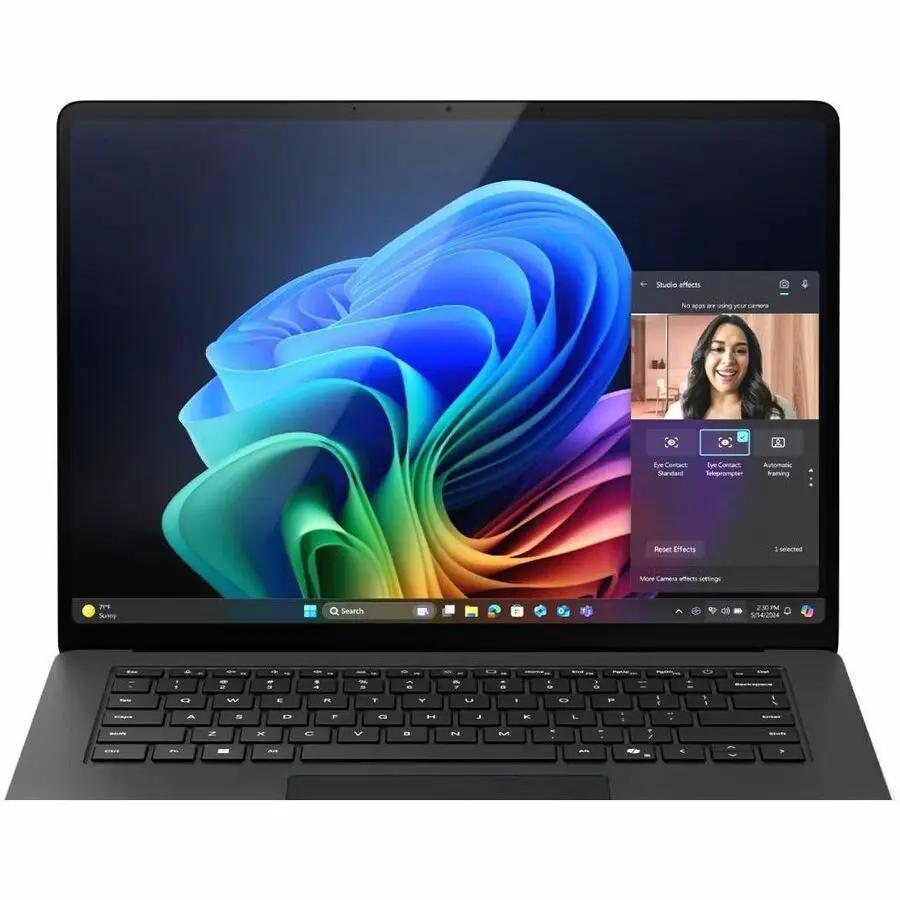 Microsoft Surface Laptop 7, space-gray chassis, open showing Windows desktop.