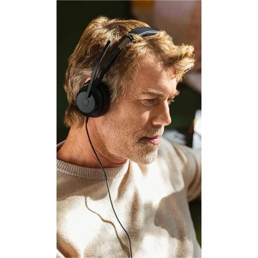 Jabra Evolve2 50 over-ear wired headset worn by a man, black.