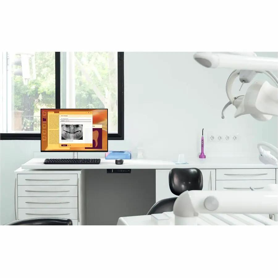 Dell Pro Micro QCM1255 Mini PC on white dental-office desk with monitor in a dental clinic.