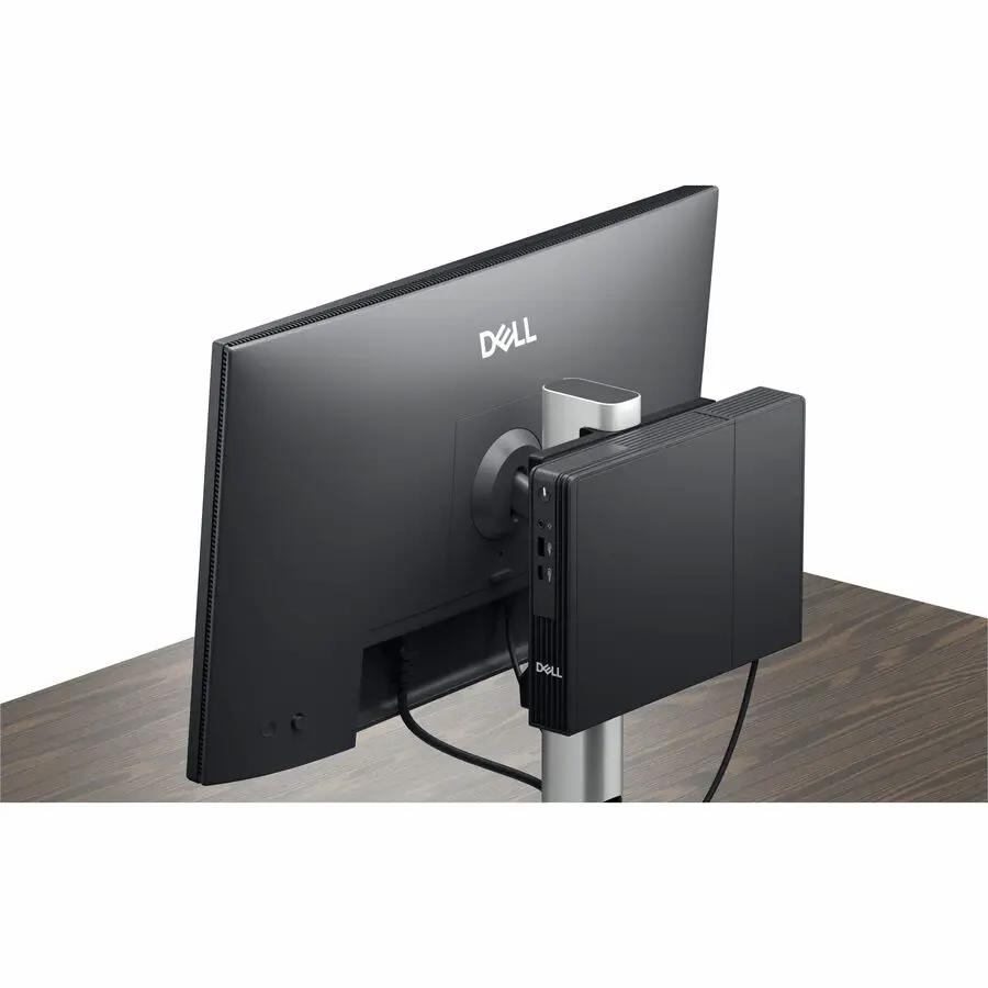 Dell QCM1250 mini PC mounted behind a black Dell monitor on a desk