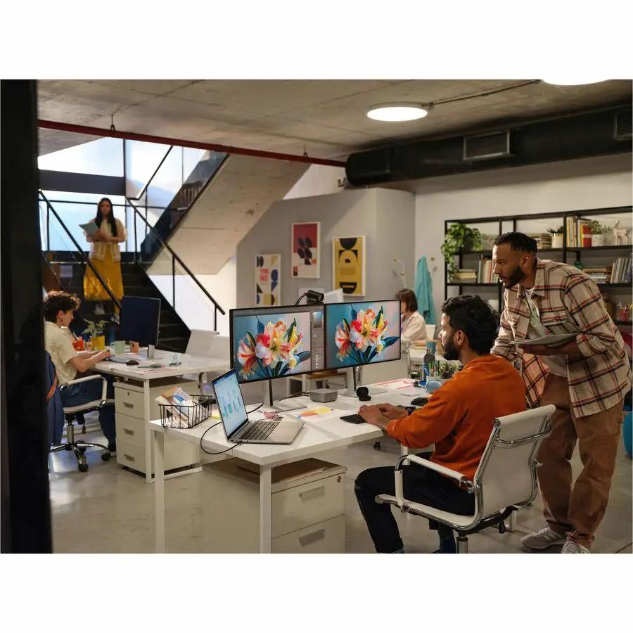 HP ZBook 16 laptop, silver, on a white desk in a busy open-office with dual monitors