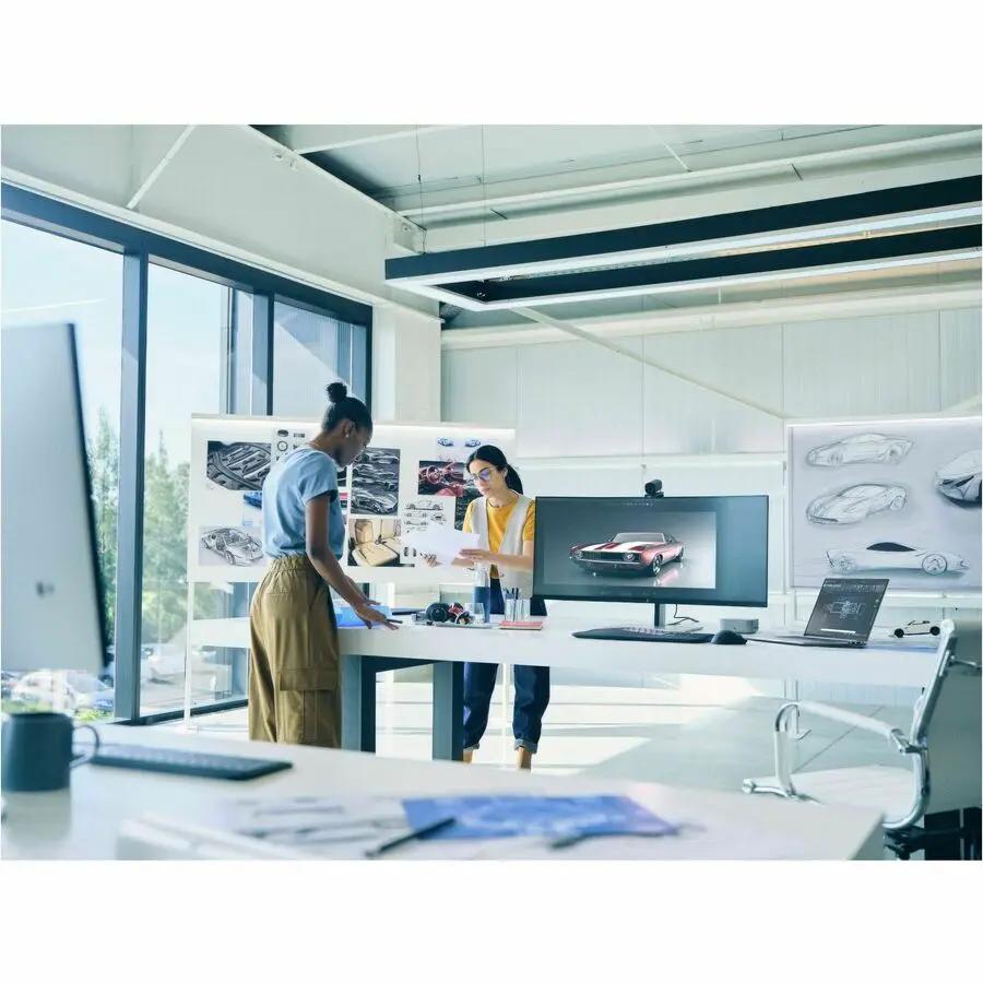 HP ZBook 16 laptop on a desk in an open-plan design studio.