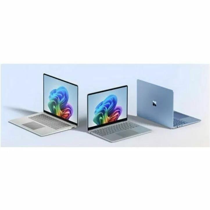 Microsoft Surface Copilot PC Notebook laptops; three devices shown in silver and blue finishes.