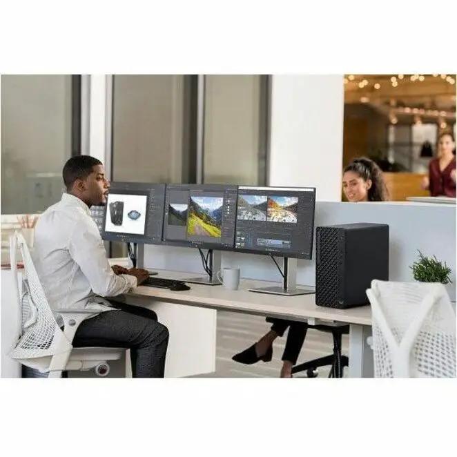 HP EliteDesk 8 G1i desktop computer with black tower and three widescreen monitors on an office desk