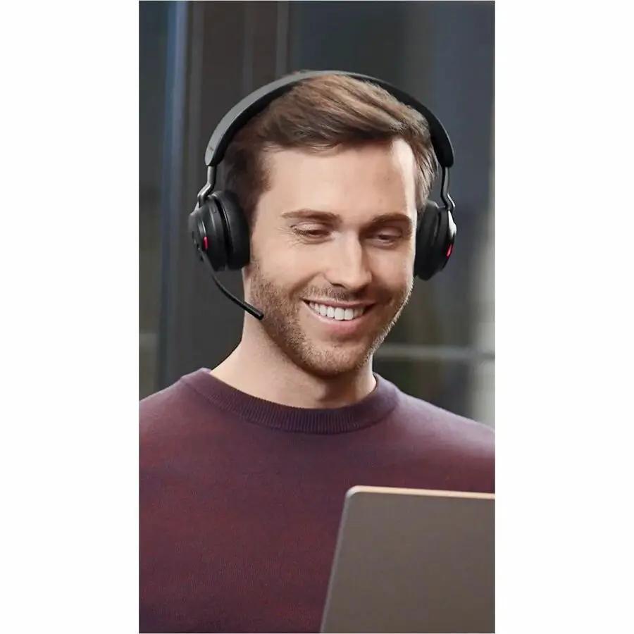 Jabra Evolve2 65 MS Stereo wireless headset on a man; black over-ear with boom mic.