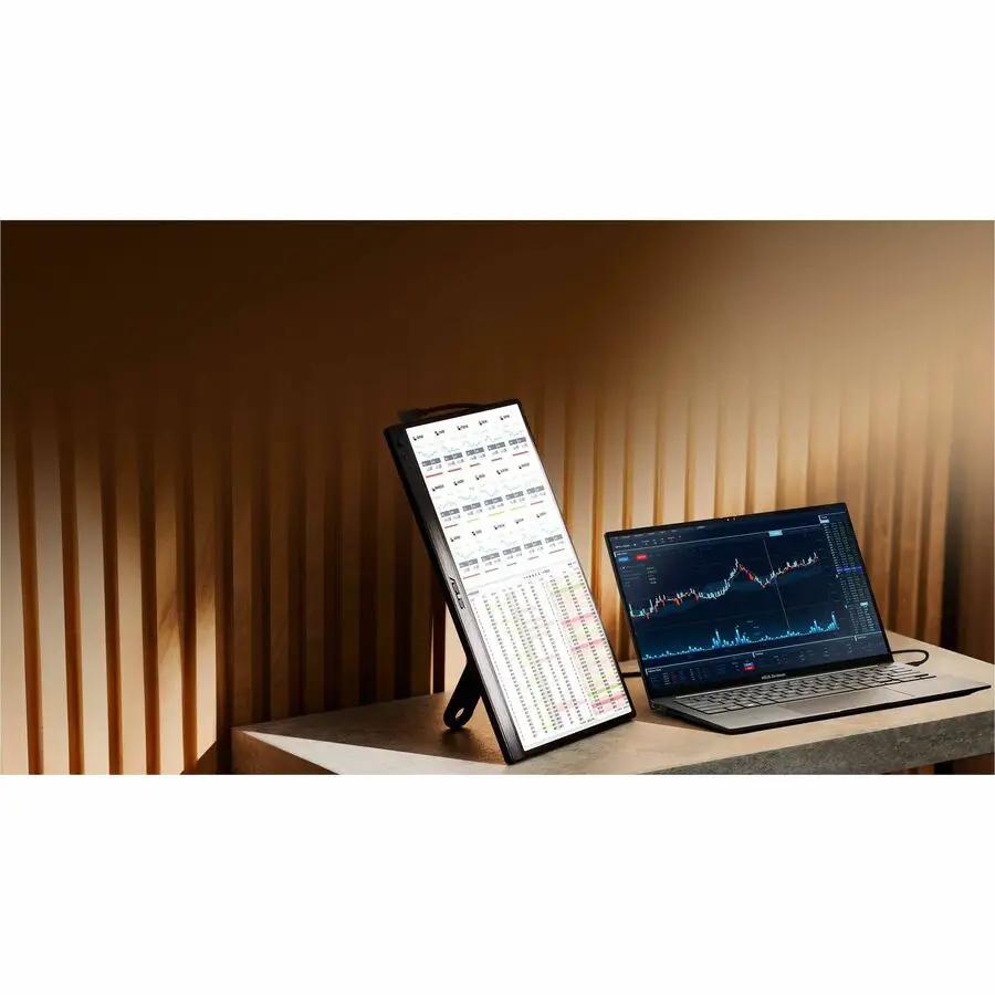 ASUS ZenScreen MB169CK-P 15.6-inch portable monitor on a desk beside a silver laptop
